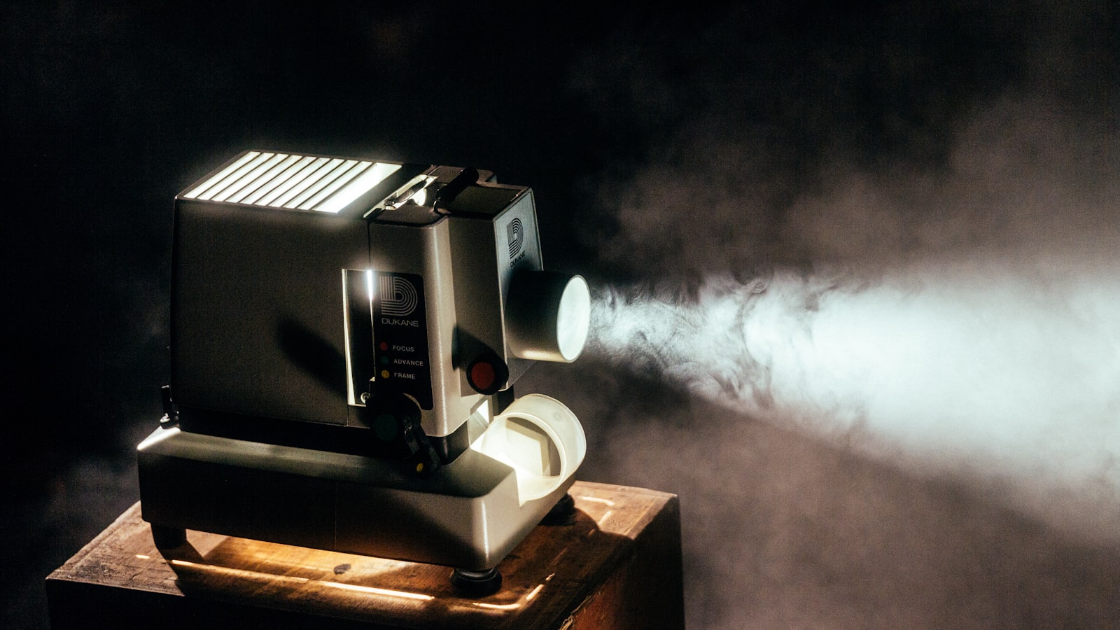 A film projector casting light through smoke